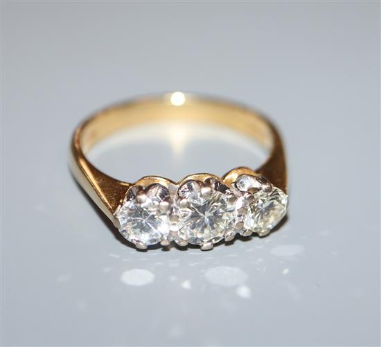 A modern 18ct gold and three stone diamond ring, size L.